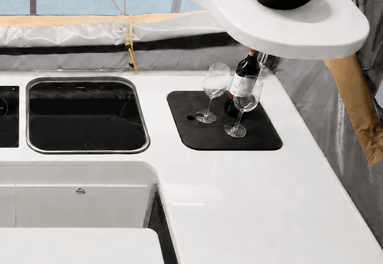 Black chopping board fitted into the galley benchtop